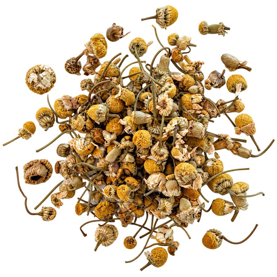 Actual image of substance used: dried chamomile flower heads with stems loosely piled on a white background